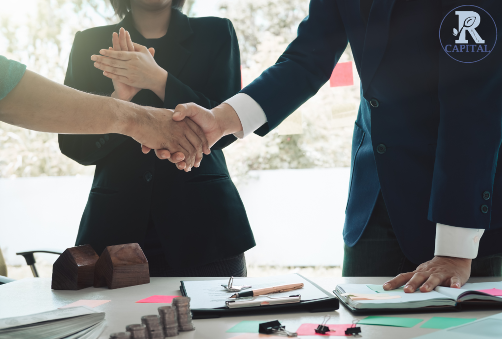 Investors discussing Real Estate Syndication strategies for passive income generation