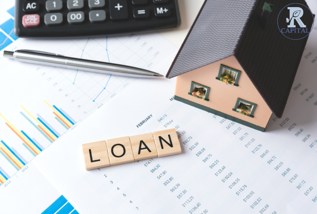 Investor analyzing real estate loan documents with property models and growth chart